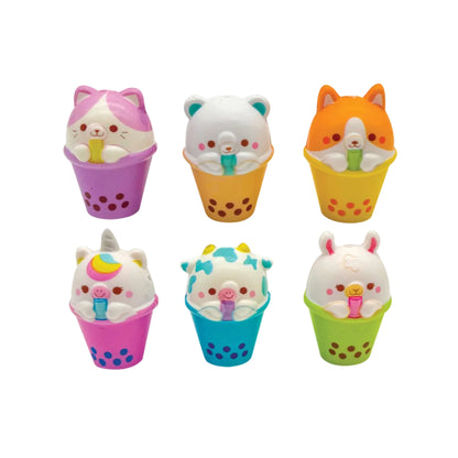 Set of colorful animal-themed ice cream figurines in polka dot cups on a white background
