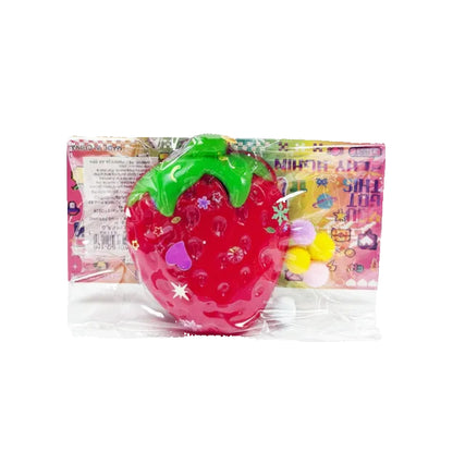 Strawberry-shaped squishy toy with packaging in the background